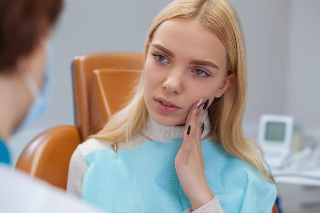 Woman visiting dentist for teeth examination.