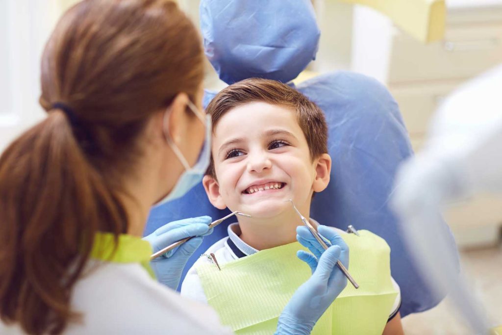 A child with a dentist in a dental office.