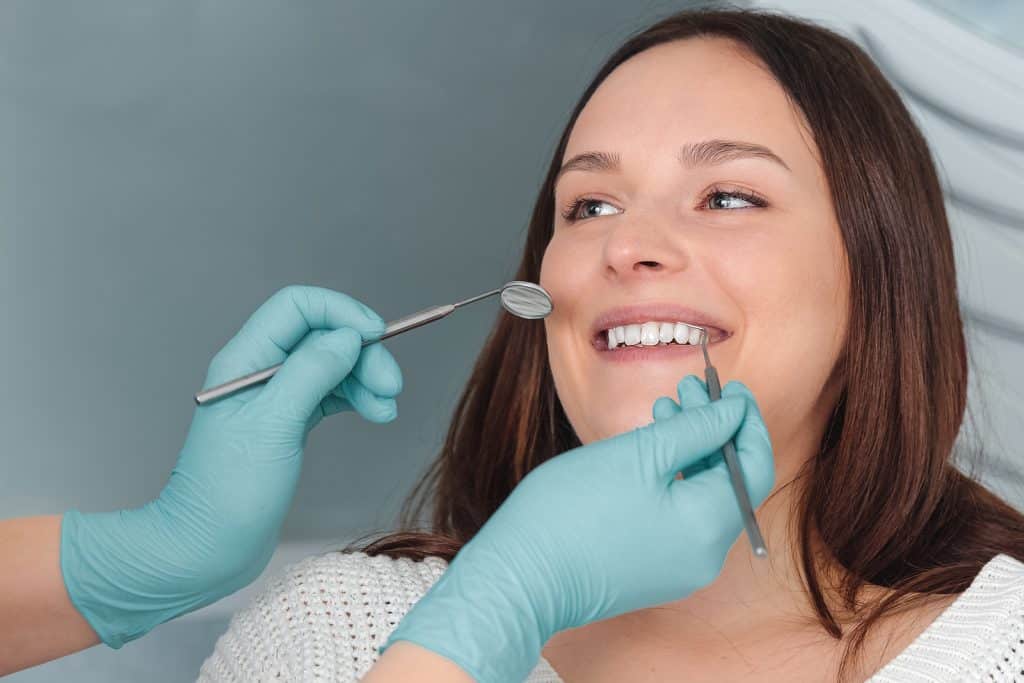 Portrait of happy young women taking dental checkup at clinic