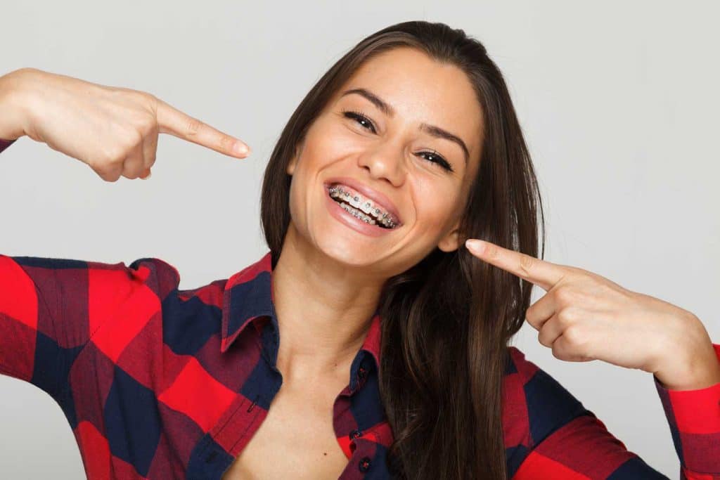 Face of an adult woman with braces on her teeth