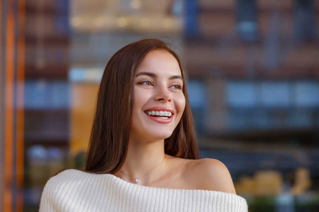 Happy smiling young woman with braces