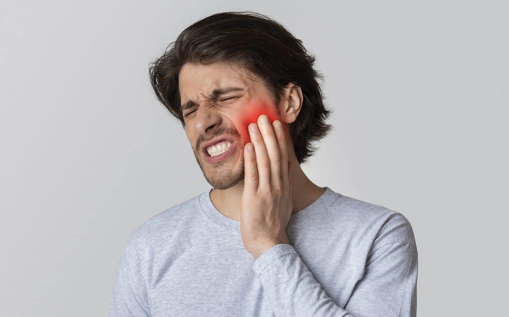 Man suffering from tooth pain|Man suffering from tooth pain