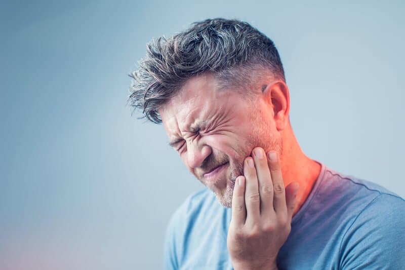 man suffering toothache
