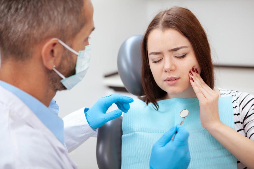 Young woman having toothache