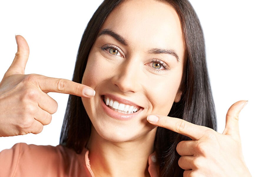 Woman Pointing To Her Smile With Perfect White Teeth|Woman Pointing To Her Smile With Perfect White Teeth|Woman Pointing To Her Smile With Perfect White Teeth